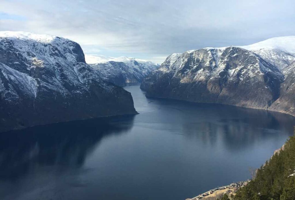 The stunning Norwegian fjords, still with snow on the mountain peaks high above the water during autumn. 