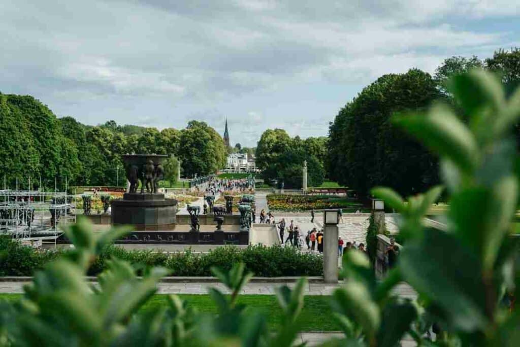 Frognerparken park in Oslo in summer, full of green trees, grass, and flowers