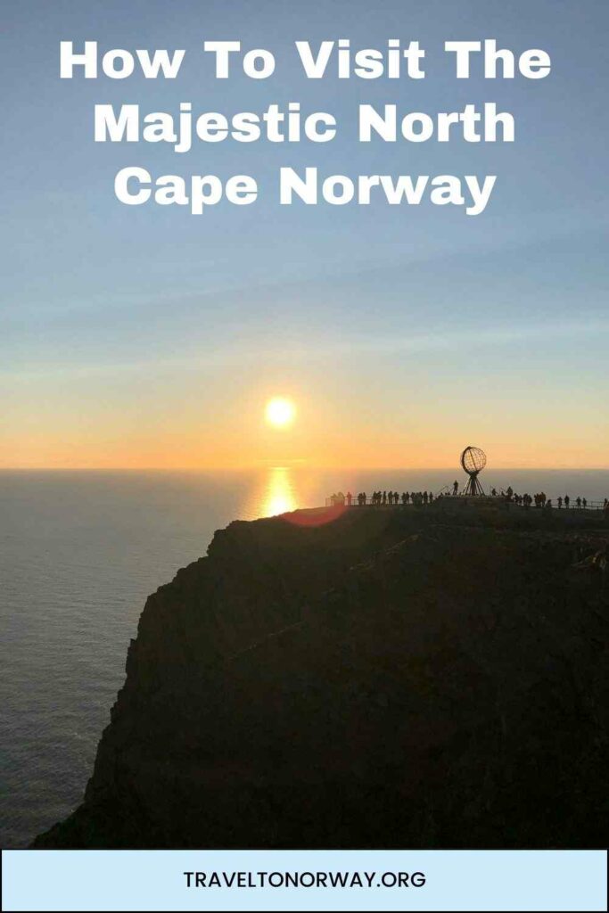 The famous North Cape plateau with the midnihht sun glowing in the horizon right over the vast deep blue Barents Sea. 