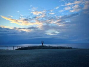 The North Cape on a clear night, surrounded by blue lights with the sea in the background