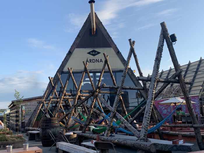 Salt Sauna, restaurant and bar in central Oslo, a pyramid shaped building with outdoor seating, hammocks, and street art style decor