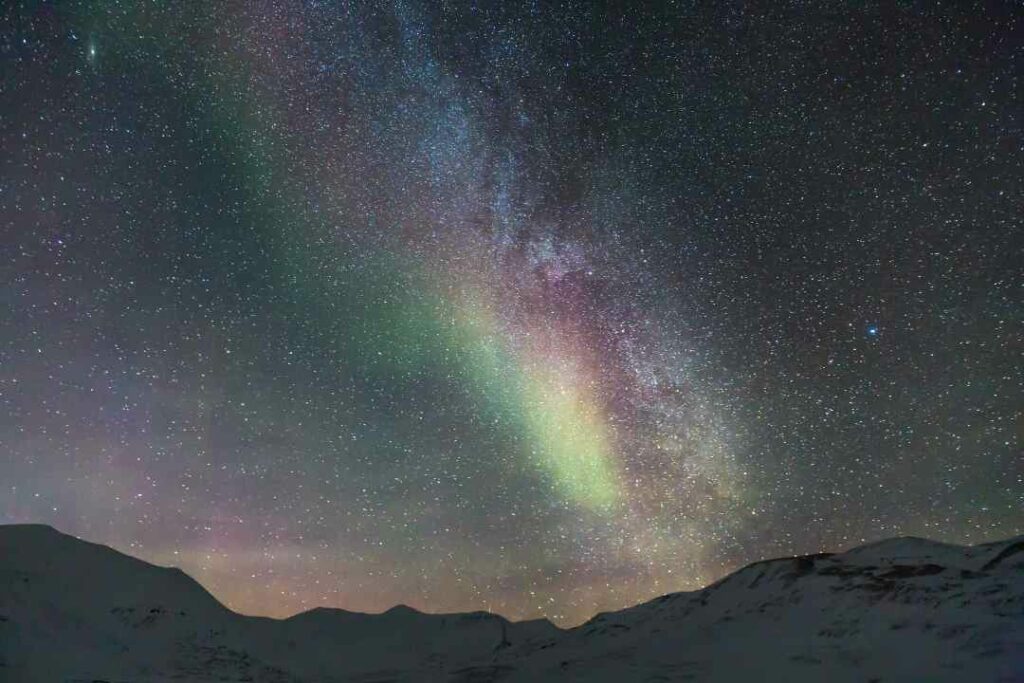 Multi colored Aurora Borealis in Svalbard against the starry night sky