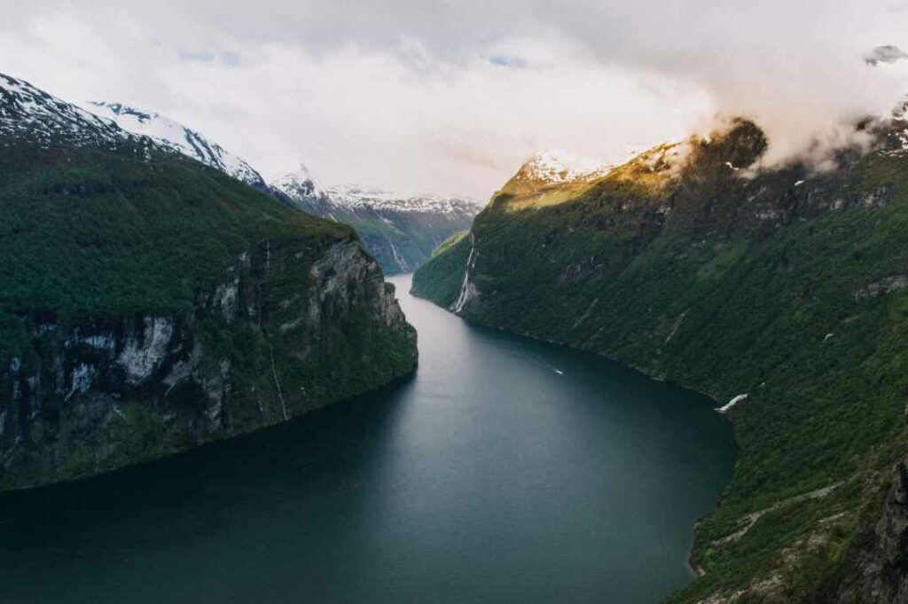 The dark water in the beautiful Geirangerfjord in Norway, surrounded by steep mountain sides