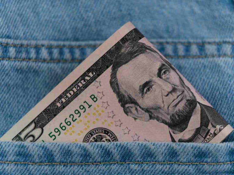 US dollars in a jeans back pocket