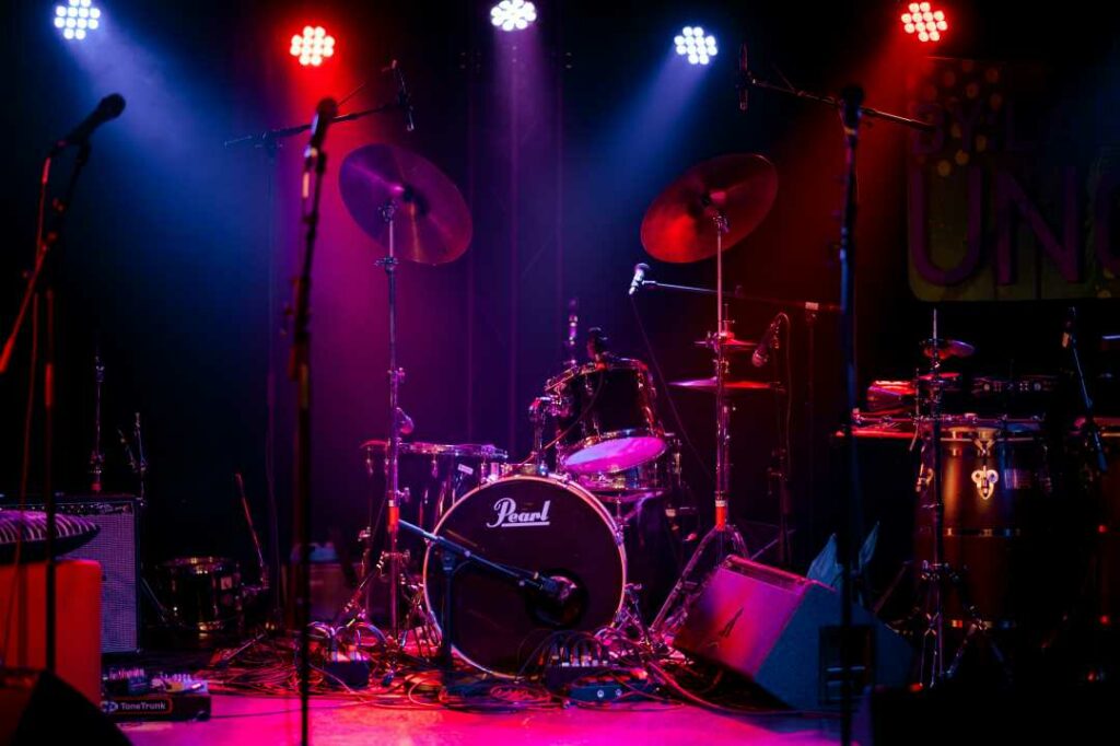 A drum set on stage under colored lights during the By:Larm festival in Norway