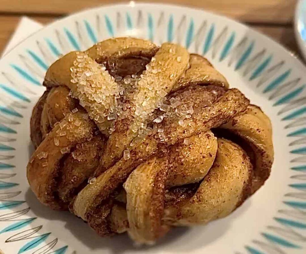 Deliscious looking cinnamon bun with lots of cinnamon and sugar at the bakery in Å, Lofoten, Norway