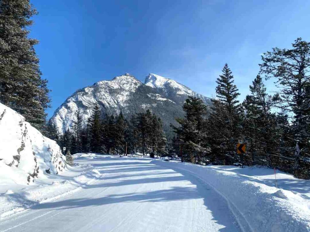 snow covered road on a sunny mountain in winter