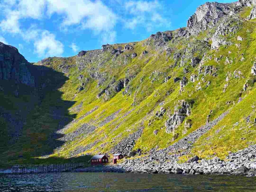 The bay and jetty that was the old way to the north cape until the fifties, the steep crisscrossing path up to the plateau, the green hillsides bathed in bright sunlight, and a red little house nestling by the waterline welcoming you. 