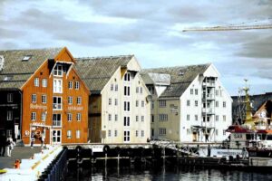 Charming wooden colorful houses by the harbor in Tromsø Norway on a sunny summer day in the arctic
