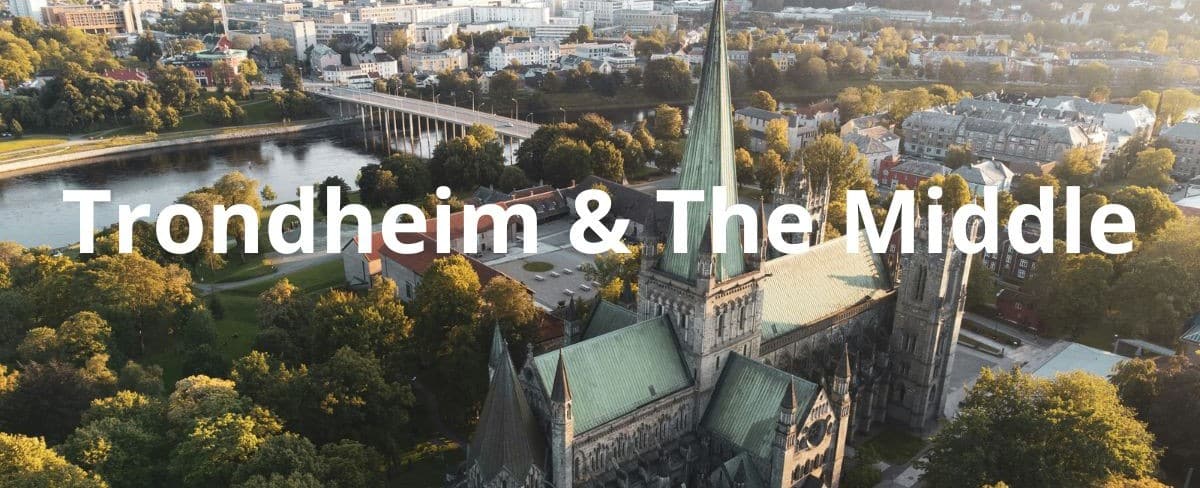 A majestic grey stone cathedral with spears and towers surrounded by forest and fjords in Trondheim Norway