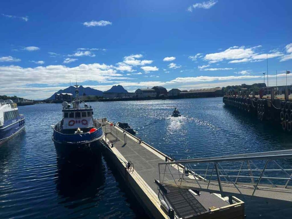 A fishing boat docked in the harbor in Svolvær Lofoten on a bright sunny summer day in northern Norway